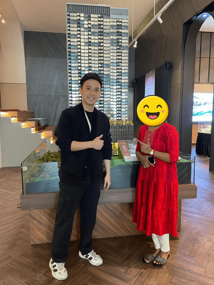 Jeremy Lee with a client at a property sales gallery
